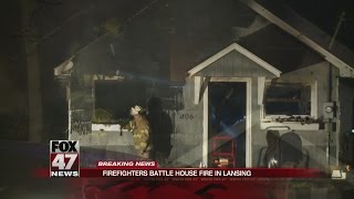 Firefighters battle house fire in Lansing [upl. by Llirrehs201]